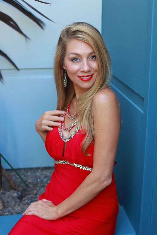 Free Beautiful Woman in a Red Dress Smiling Stock Photo