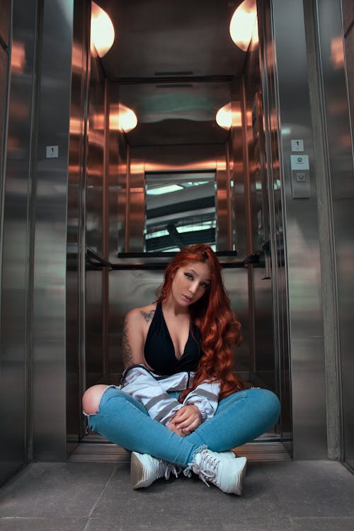 A Woman with Red Hair Sitting on the Floor