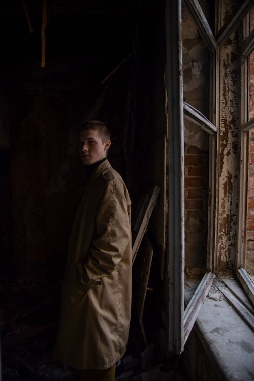 A Window Near a Man in a Brown Coat