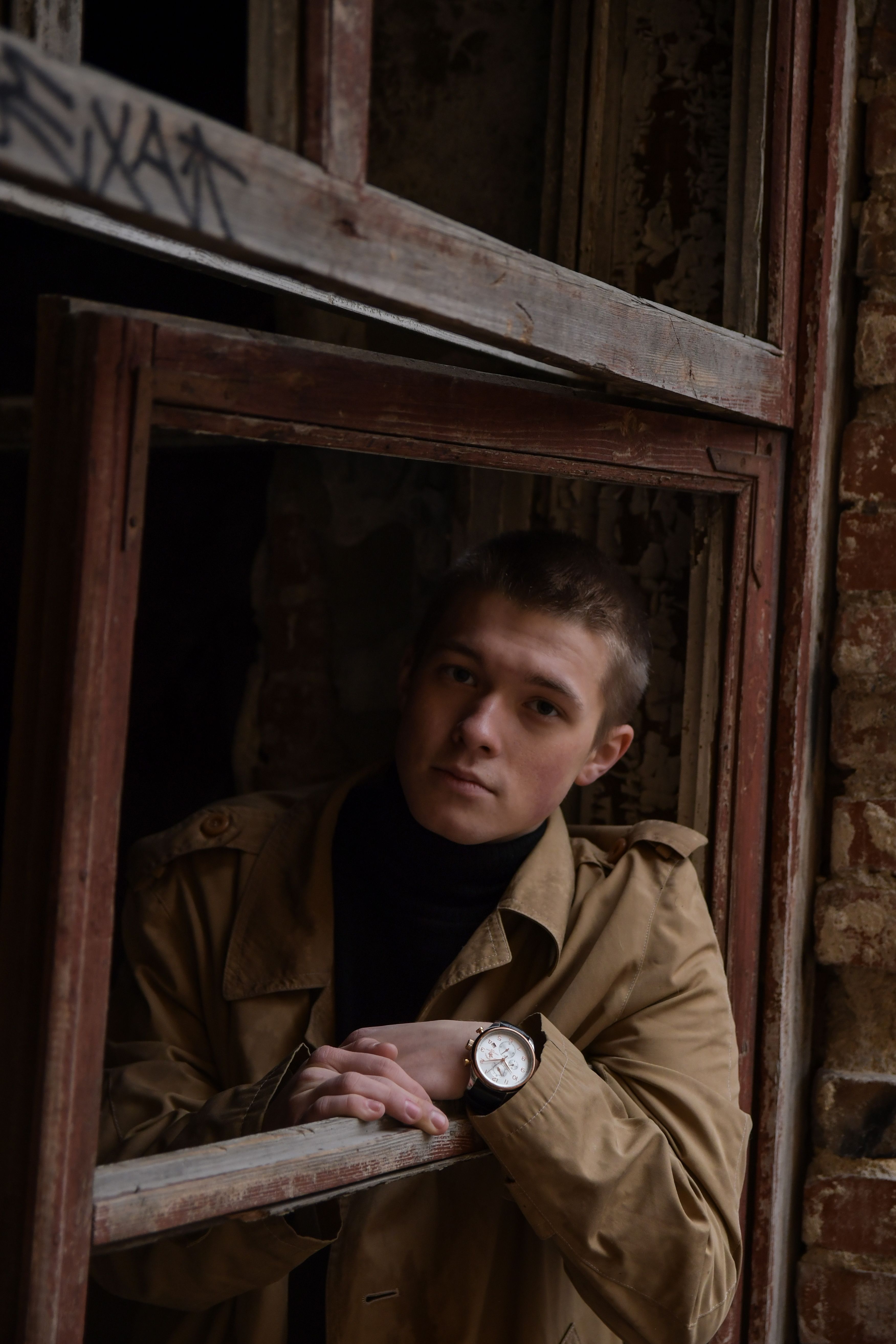 Man in Brown Coat Standing Wearing a Wristwatch Standing Near Wooden ...