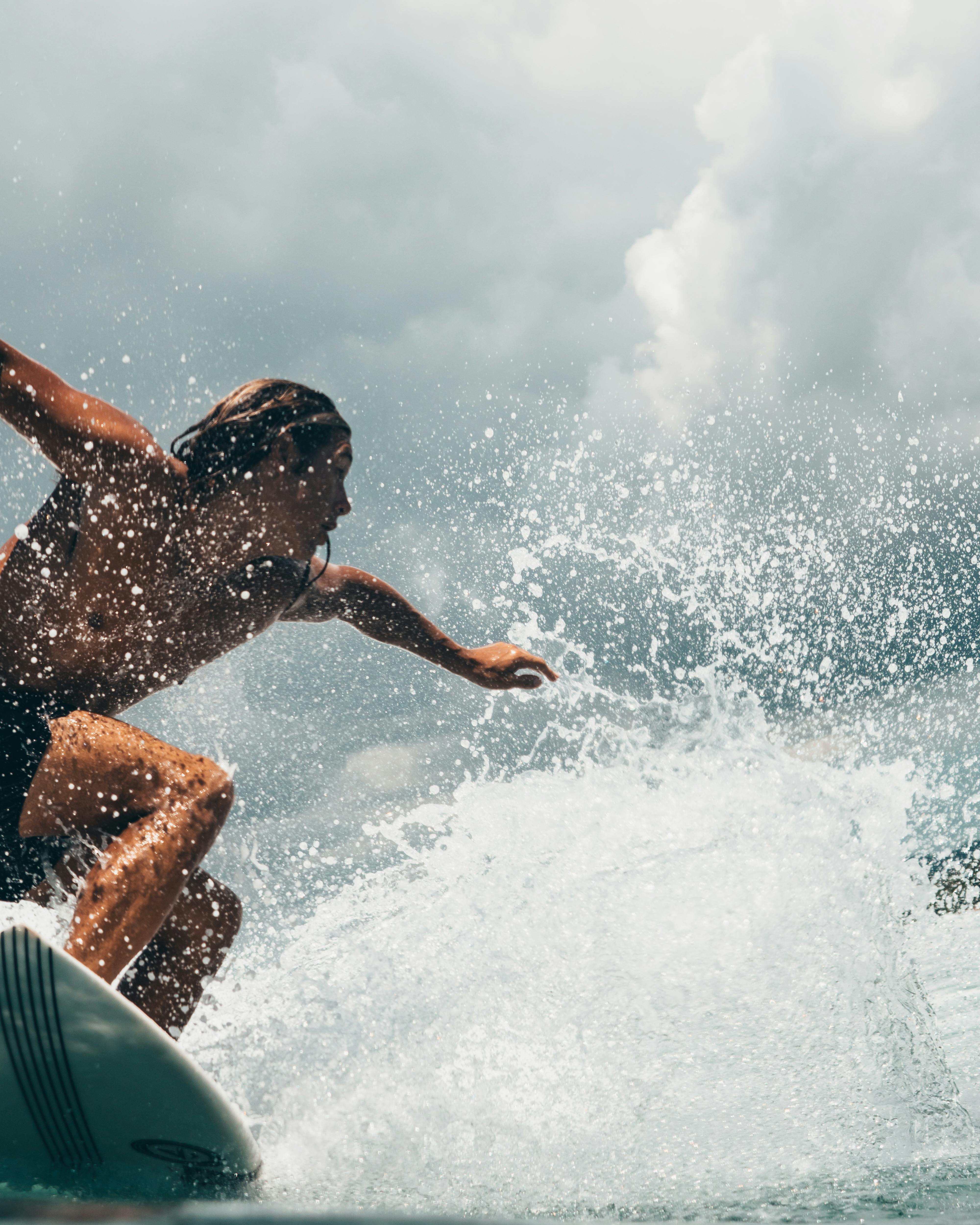 man riding white surfboard