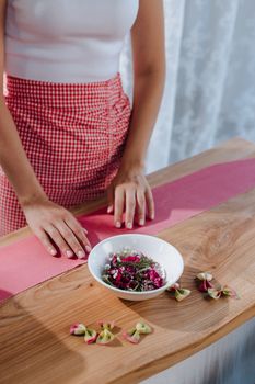 Creative food styling with colorful dish on wood table, photographed from above.