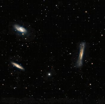 Capture of three distinct galaxies amidst countless stars in the vast cosmos.