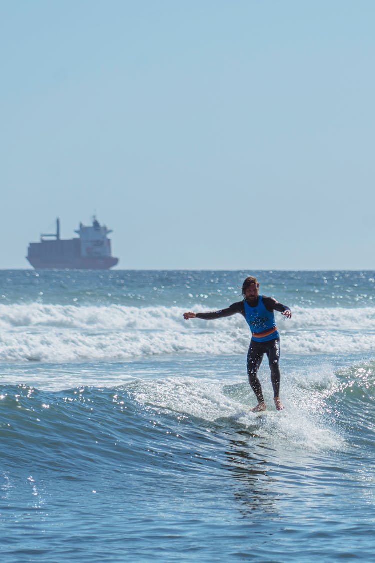 A Man Surfing At The Sea