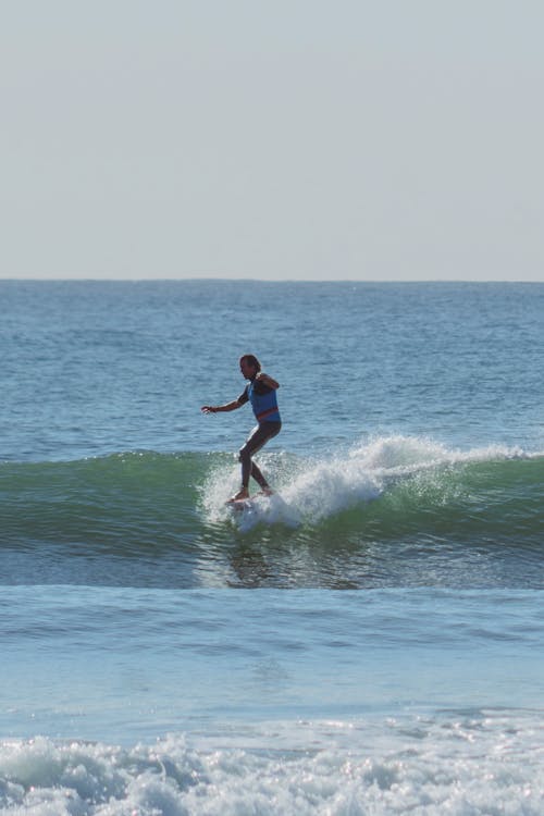 A Person Surfing on a Sea Wave