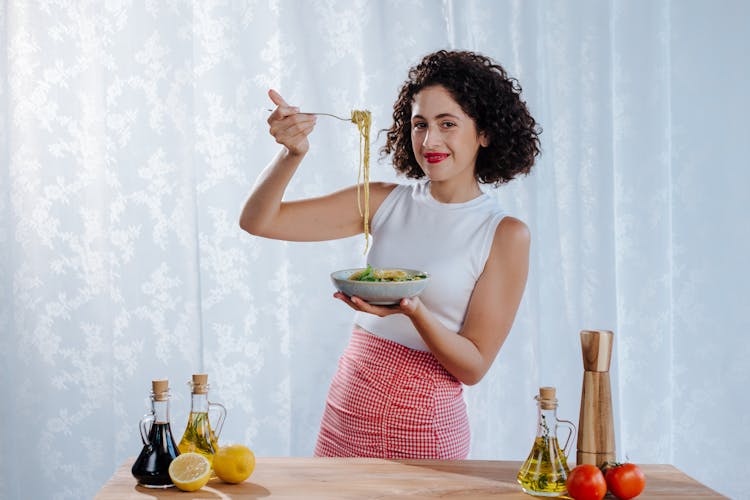 Woman Holding Bowl Of Pasta