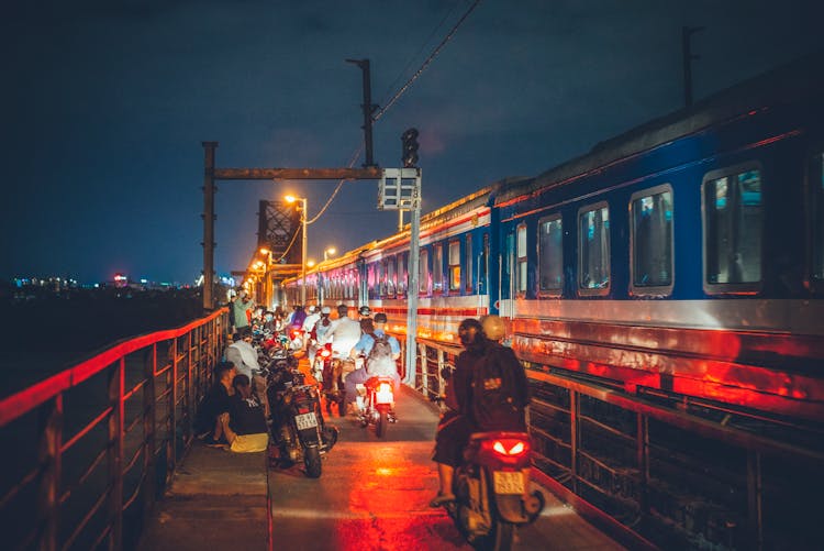 People On Scooters Near Train