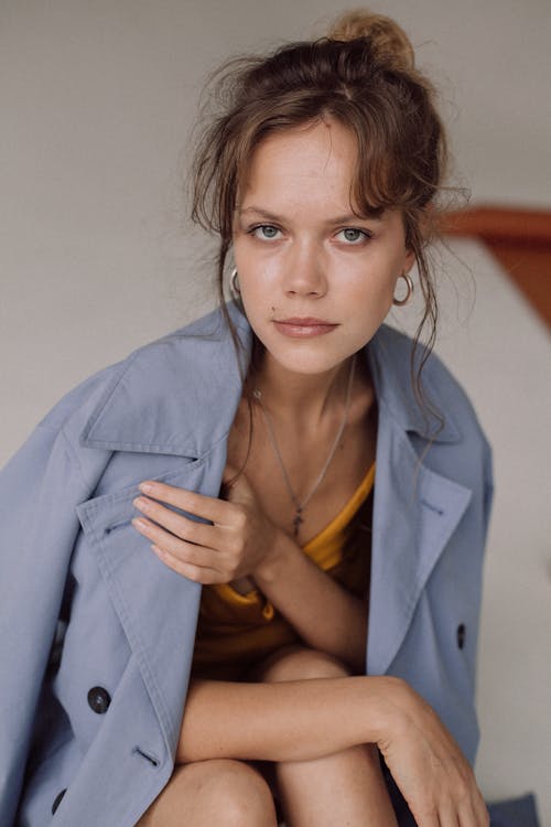 Studio Shot of Young Woman in Coat 