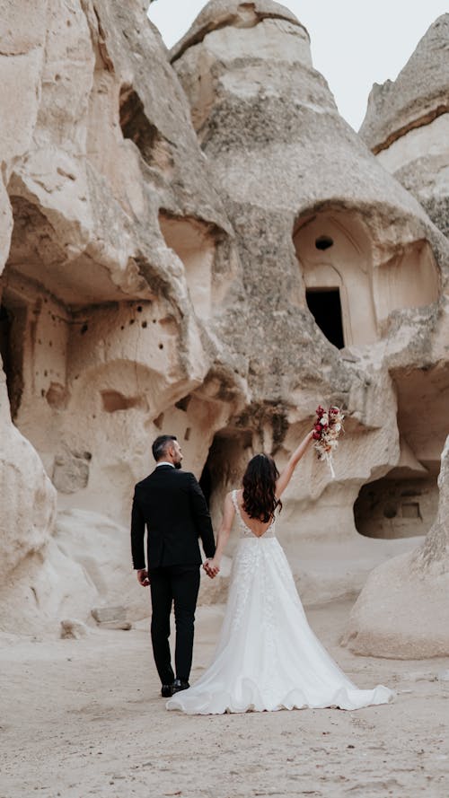 Back View of a Bride and a Groom Holding Hands