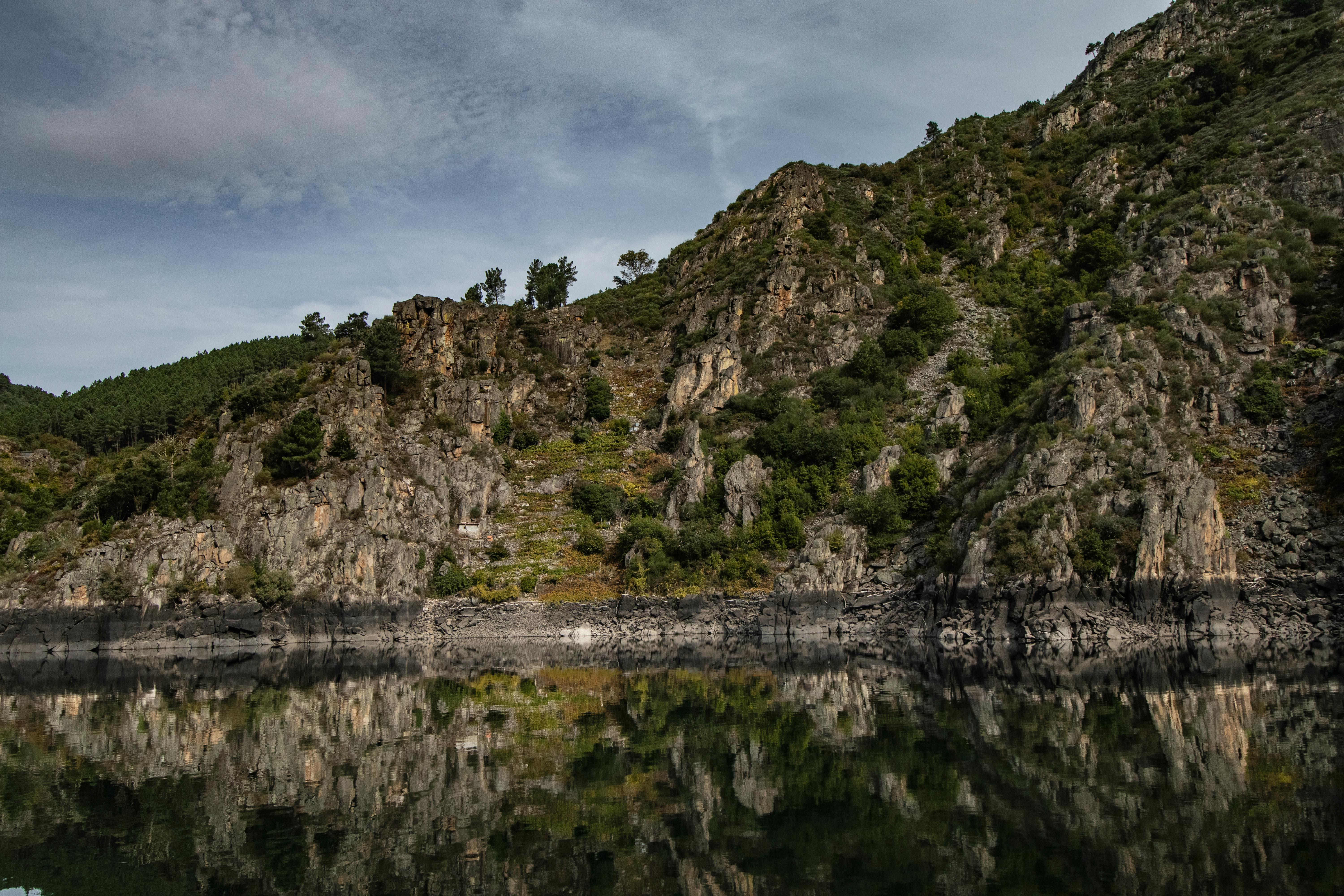 Tranquil rocky landscape with water reflection in Ourense, Spain's natural beauty.