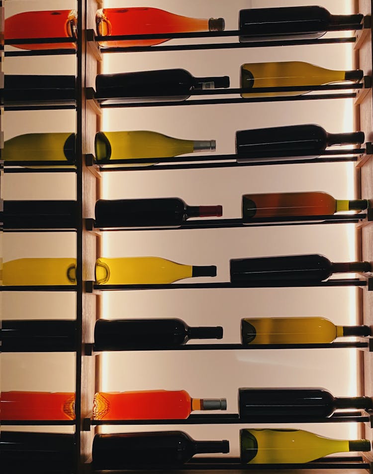 Colorful Glass Bottles Lying On Shelves 