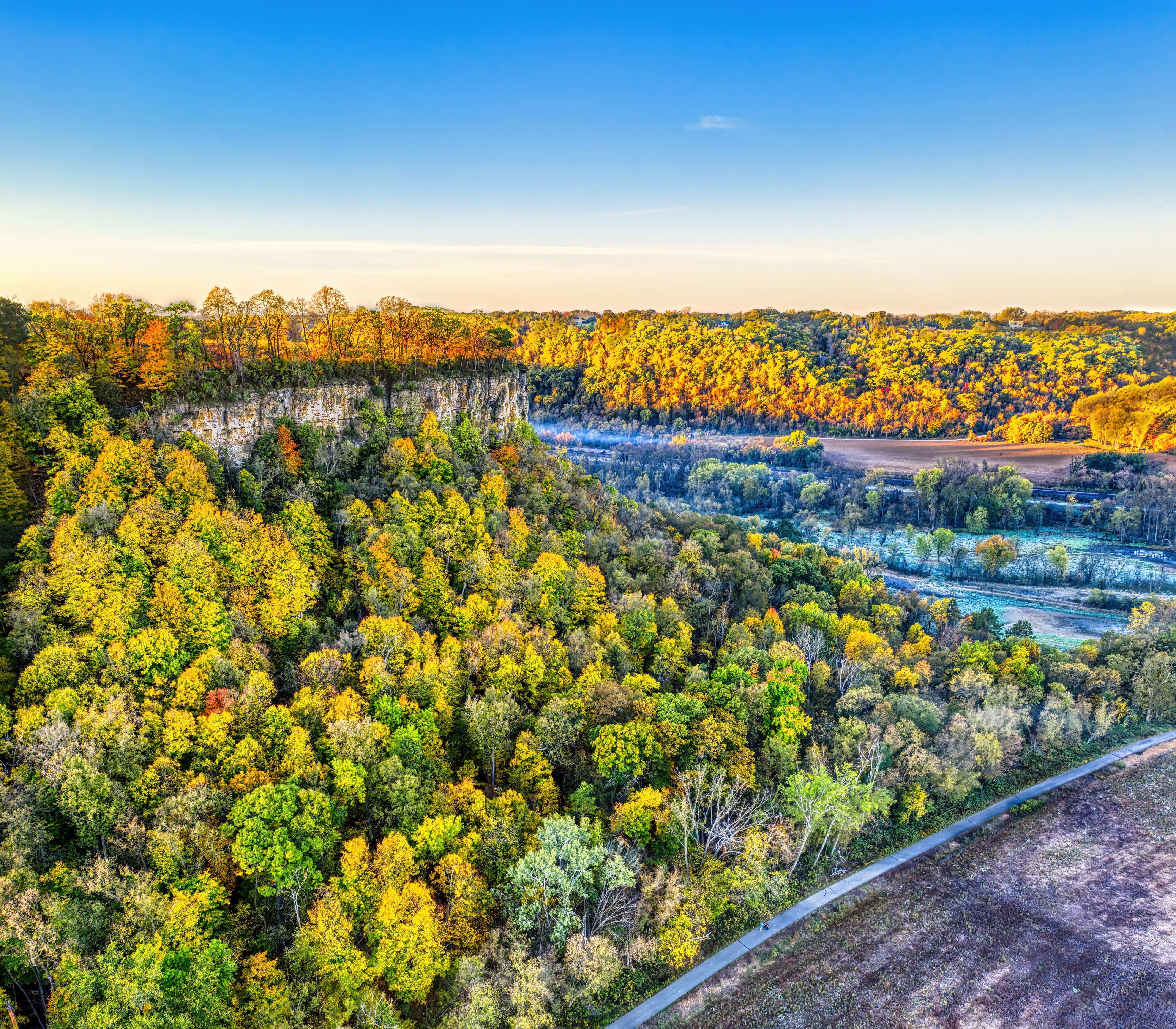 A stunning aerial view of the vibrant autumn forest and bluffs in Wacouta, Minnesota.
