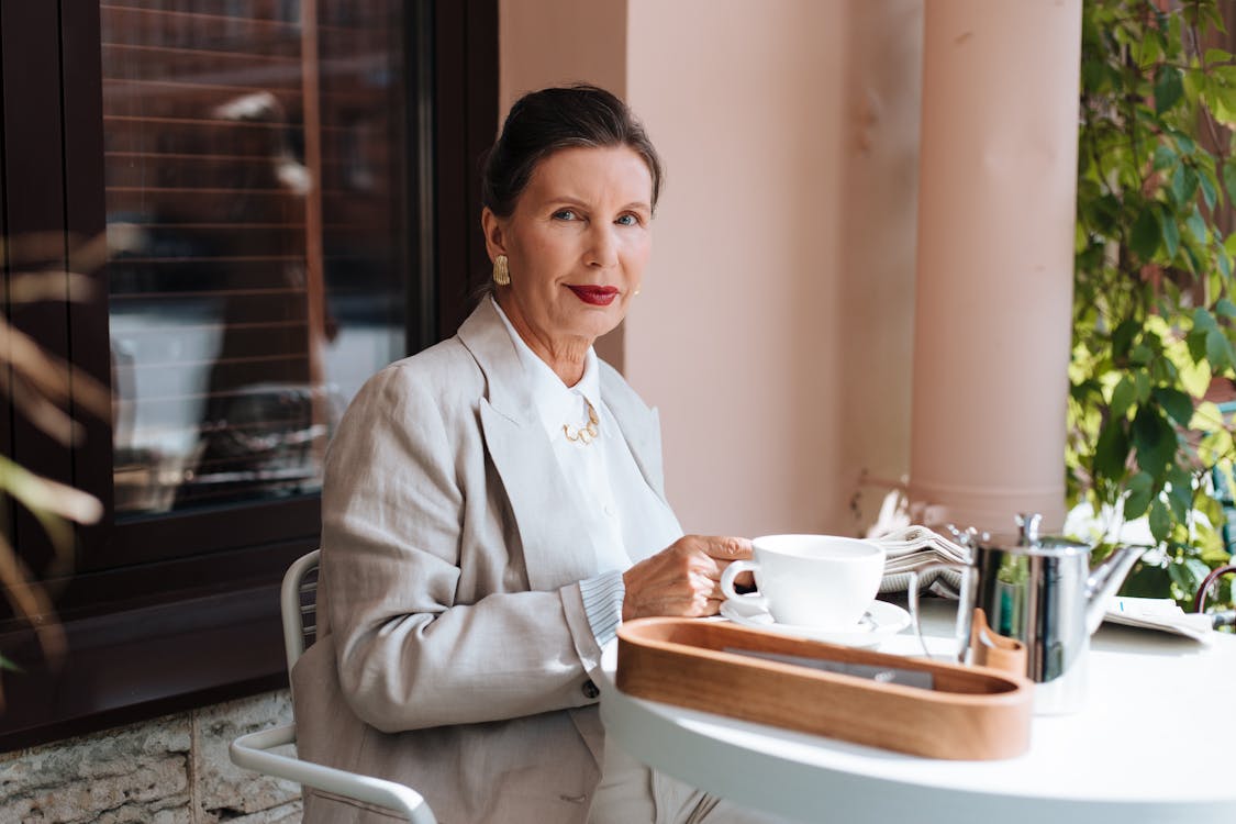 A Woman with Red Lips Having Coffee