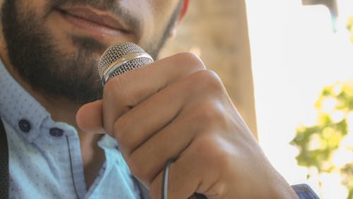 Close-up Photo of Man Holding Microphone