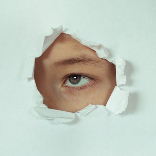 
A Person Looking Through a Hole