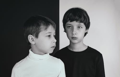 A Grayscale Photo of Boys Wearing Shirt