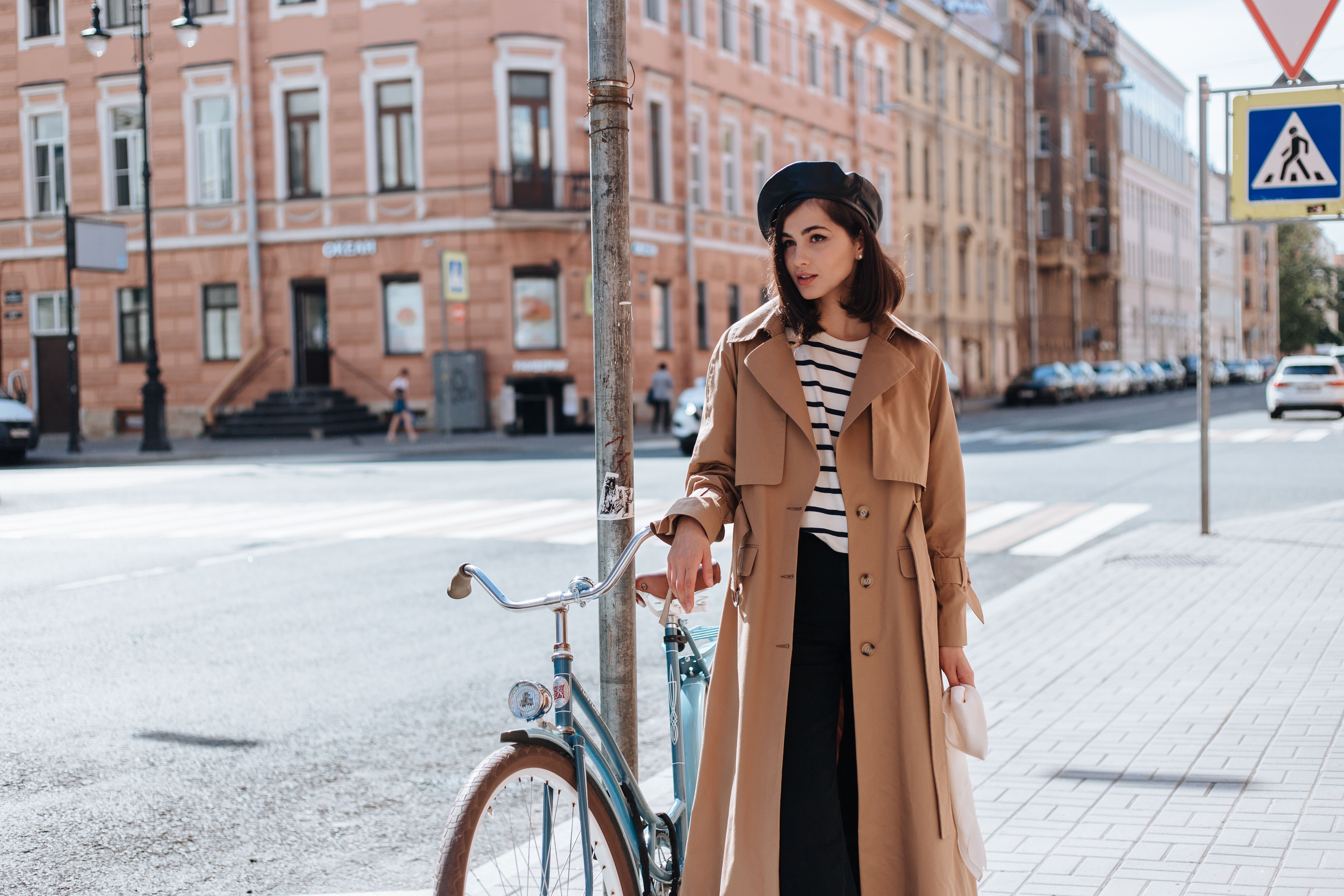 A Woman Standing on the Street Near Her Bicycle · Free Stock Photo