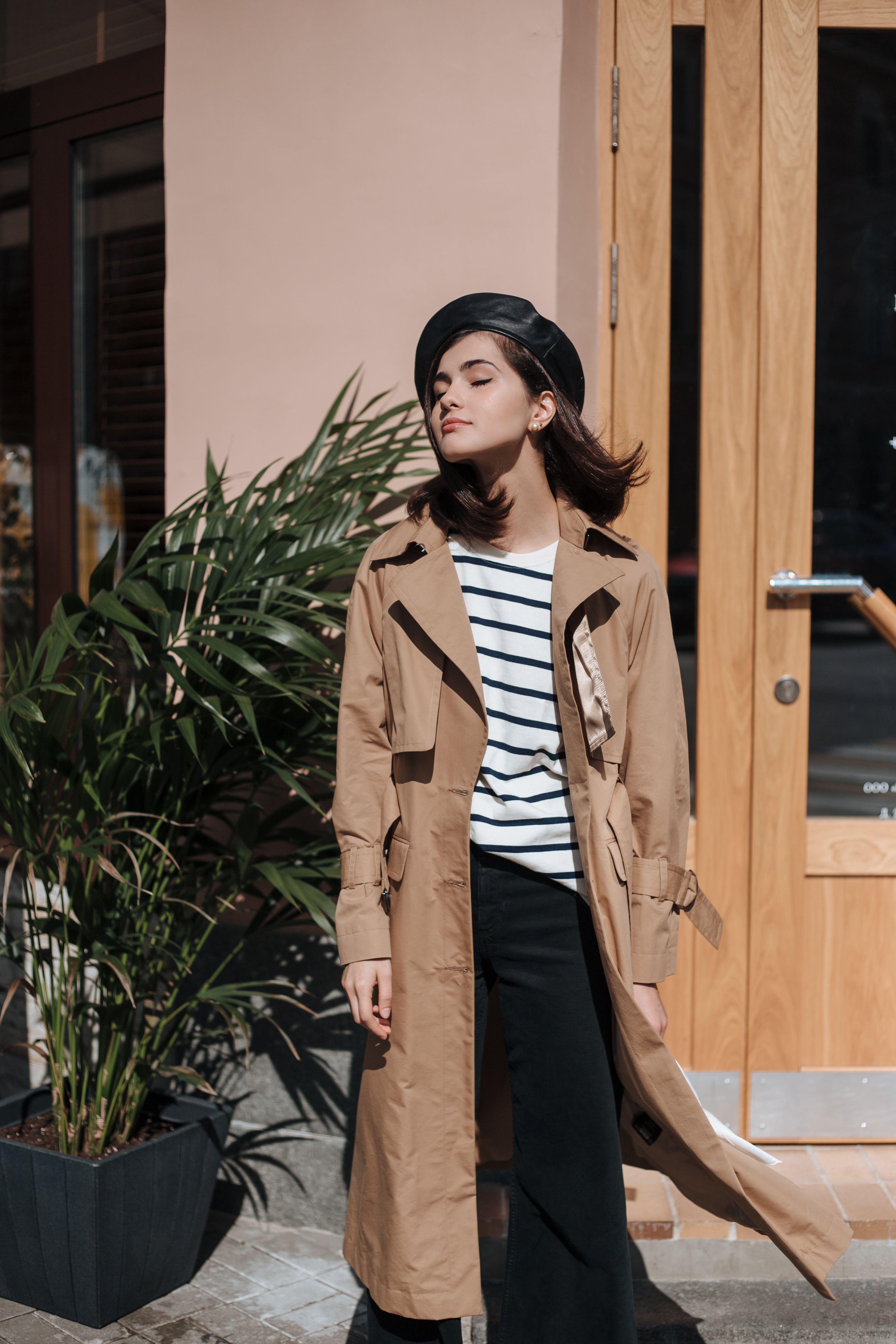 Woman in a brown trench coat showing a relaxed plus size fall outfit