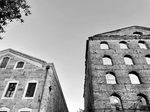 A Grayscale Photo of a Concrete Buildings Under the Clear Sky