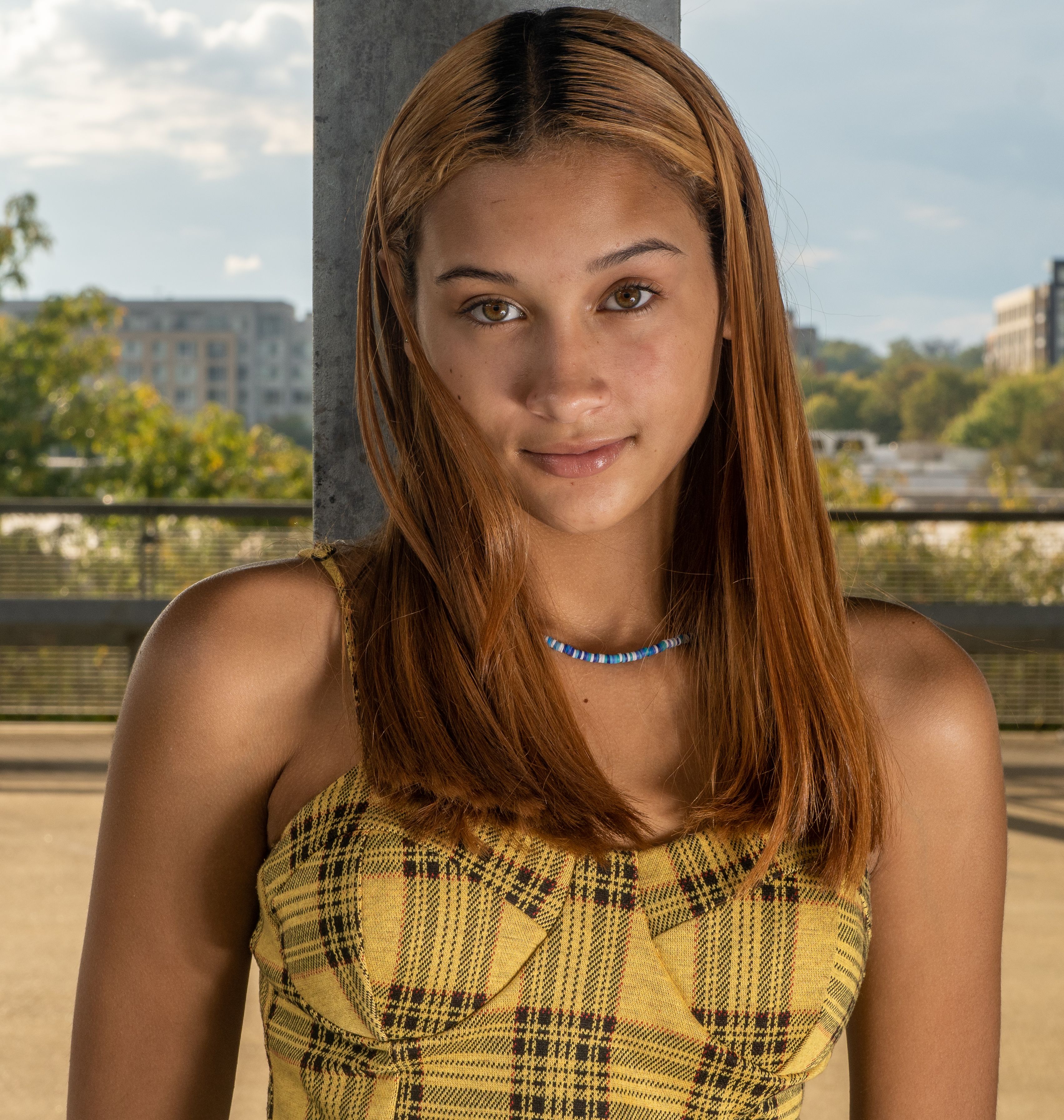 Captivating outdoor portrait of a young woman in Columbia, MD, showcasing modern fashion and natural beauty.