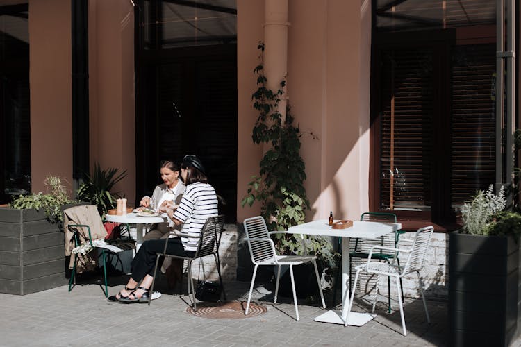 Women Eating Outside The Restaurant