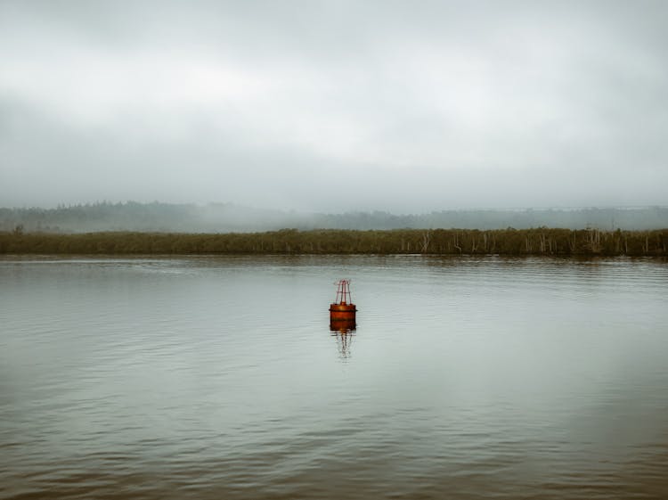 Floating Red Buoy On Body Of Water