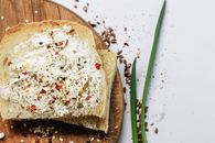 A Sliced Bread with Cream on a Wooden Board