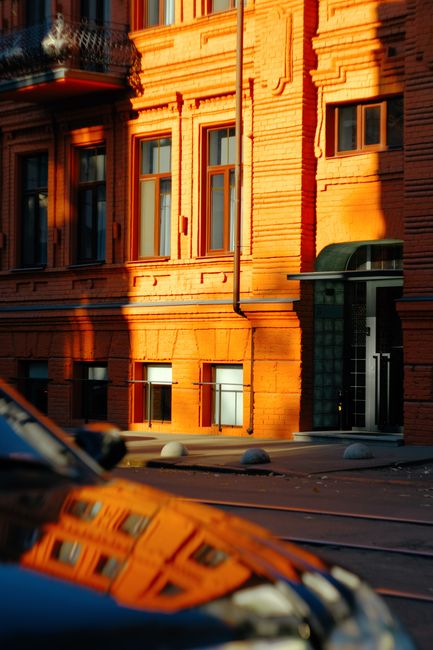 Bright sunlight casts shadows on a red brick building in Kyiv, Ukraine.