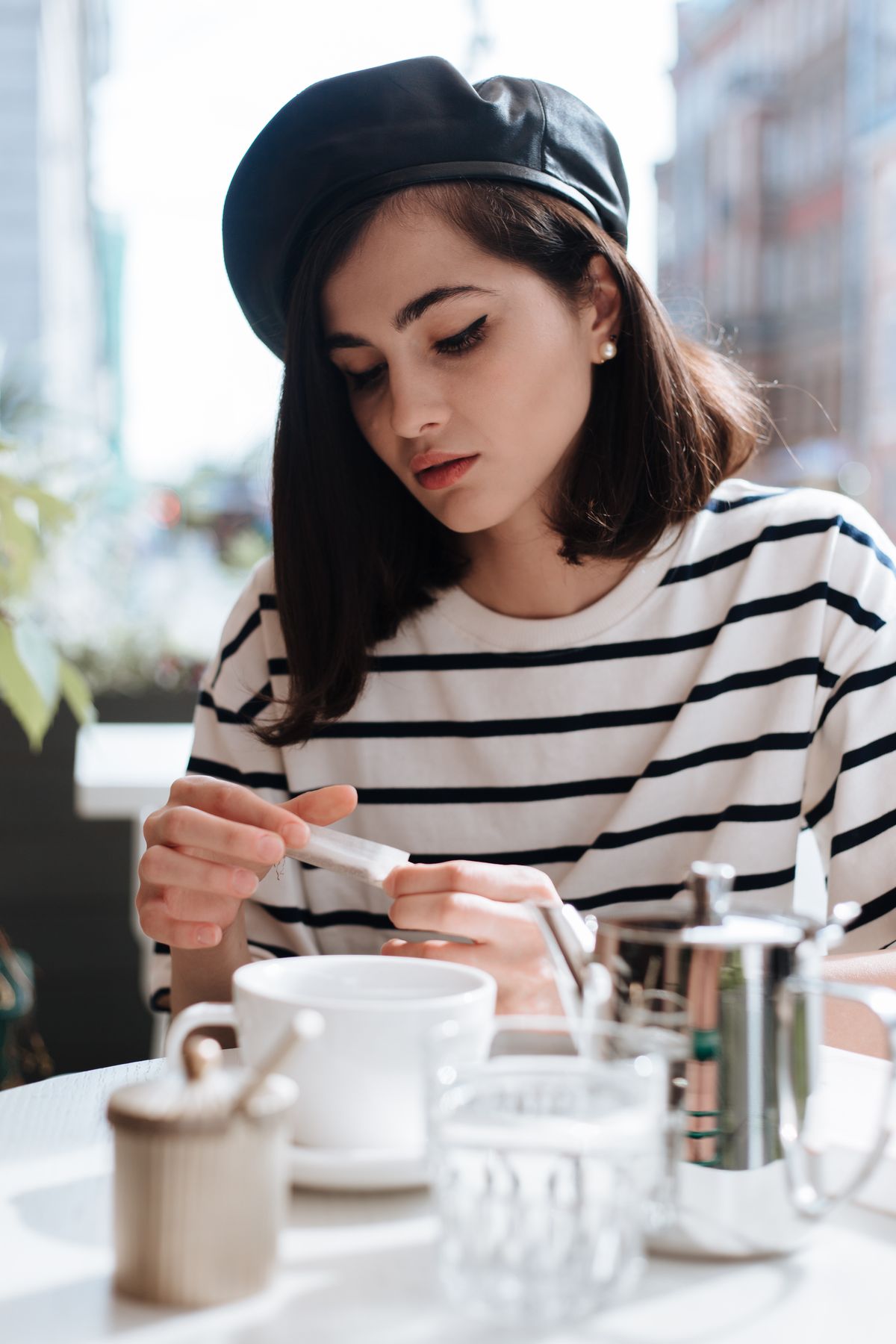 A woman in a black beret and striped shirt — the classic French look