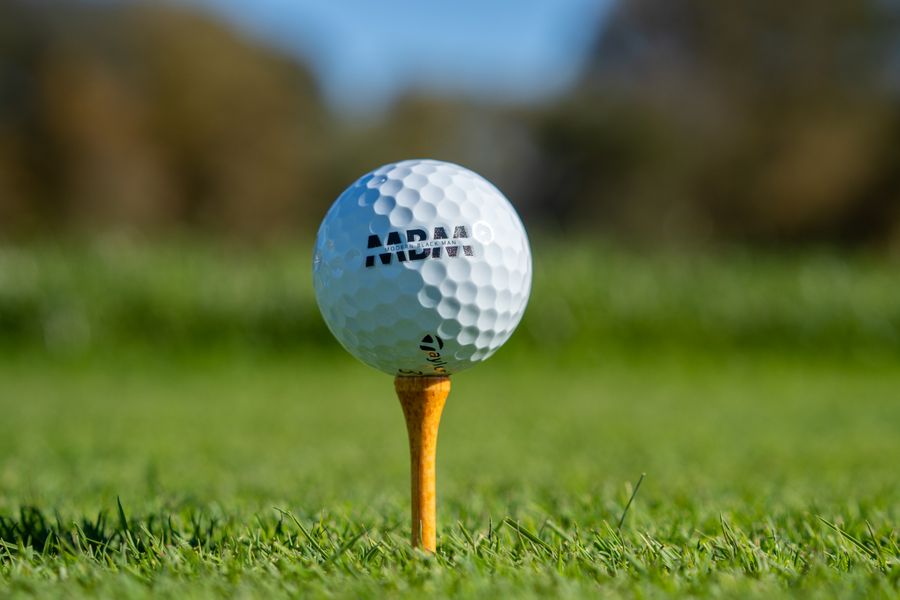Golf ball on a tee on a golf course