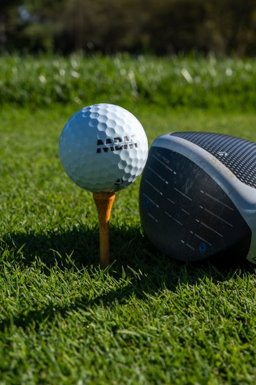 A Golf Ball and Golf Club in Close-Up Photography