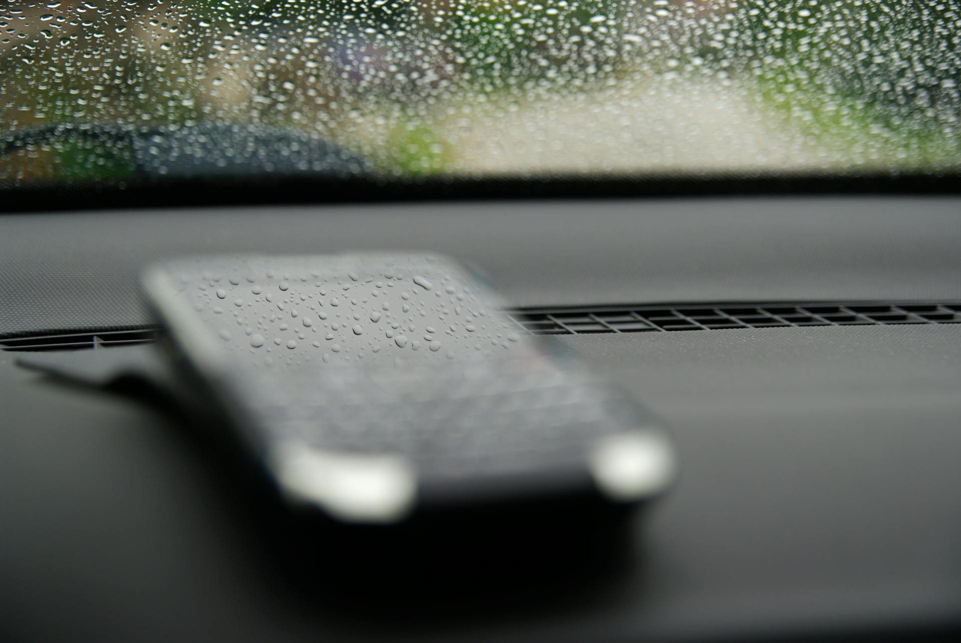 A Smartphone on Black Dashboard