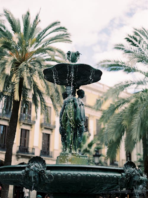 A Fountain Beside Palm Trees