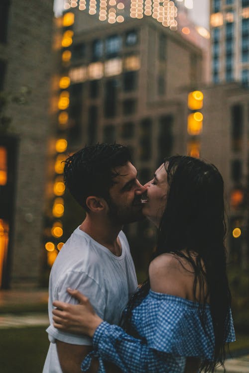 A Couple Kissing While Holding Each other