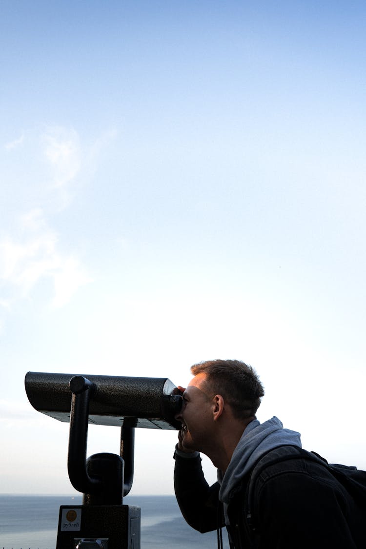 Woman Looking With Binoculars On Sea