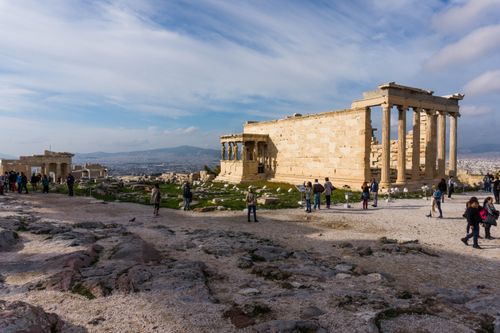 Free Tourists explore the ancient Erechtheion on a sunny day at the Acropolis in Athens, Greece. Stock Photo