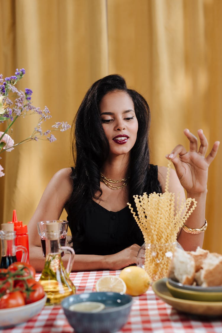 Woman Taking Pasta Strap From Glass