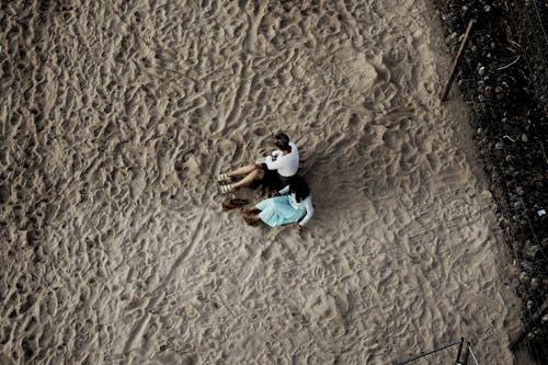 Drone Shot of Women Sitting on the Sand