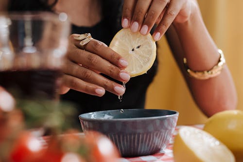 Close up on Woman Squeezing Lemon Slice