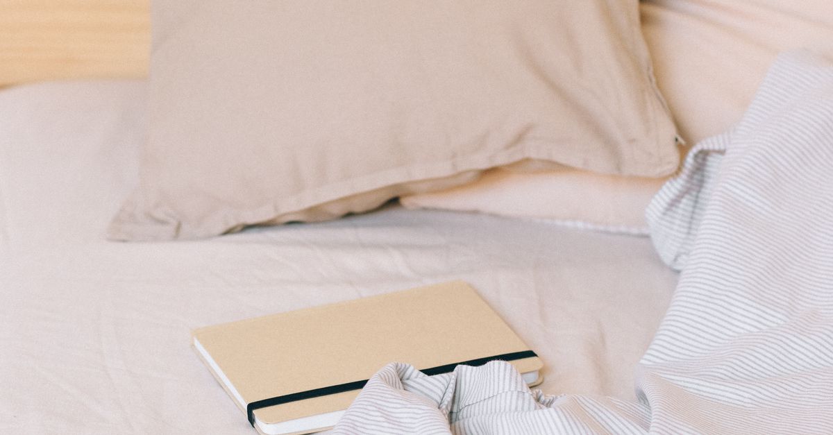 A Notebook on the Bed · Free Stock Photo
