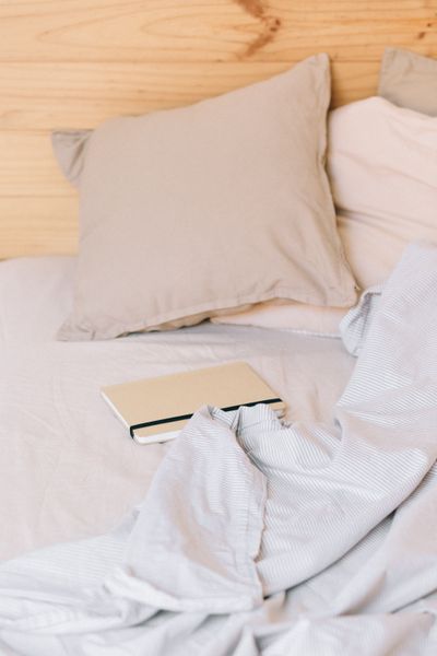Brushed cotton pillowcases on a made bed — photo by Nataliya Vaitkevich on Pexels