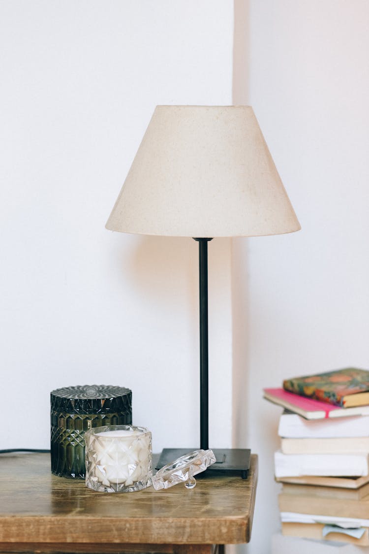 Photo Of A Lamp Near Books