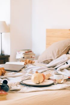 Inviting bedroom scene with a cozy breakfast setup and workspace elements, perfect for working from home inspiration.