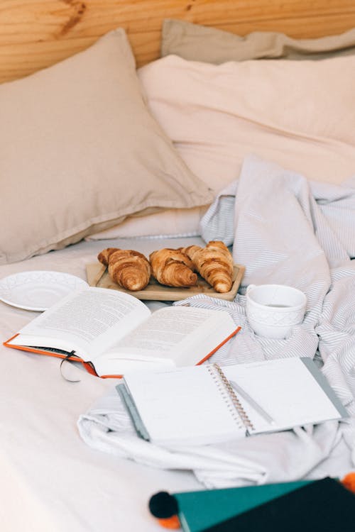 Free Photo of Croissants Near a Book Stock Photo