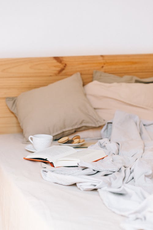 Photo of Cookies and a Book on a Bed