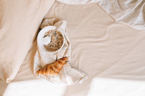 Free Cereals and Croissant in Bed Stock Photo