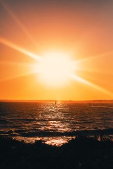 A breathtaking sunset casting warm light over a peaceful ocean horizon, creating a tranquil and vivid scene.