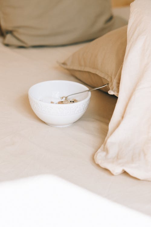 White Ceramic Bowl on the Bed 
