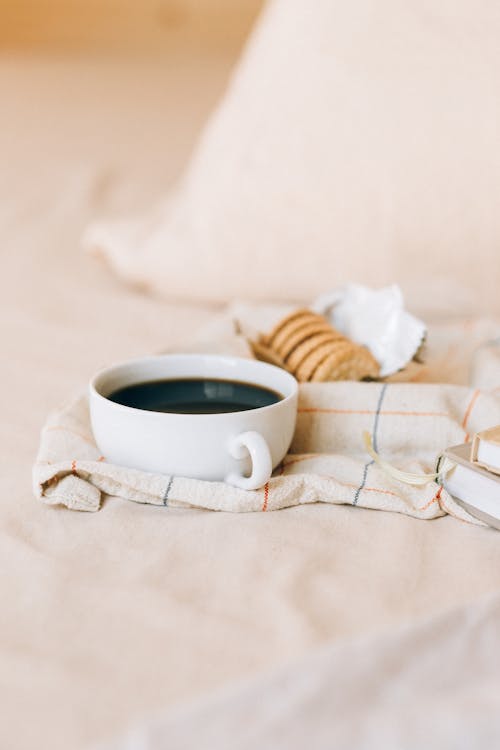 Free Biscuits and a Cup of Coffee on the Bed  Stock Photo