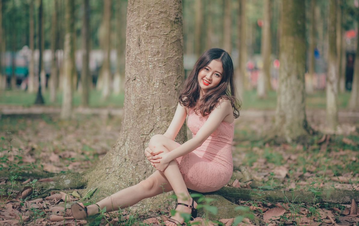 woman sitting on tree root